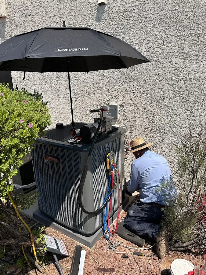 HVAC technician performing outdoor AC maintenance in West University Place